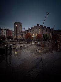 Illuminated buildings against sky at night