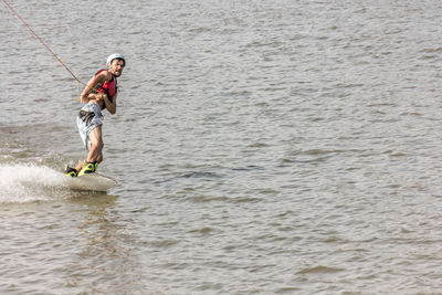 Man kite boarding in river