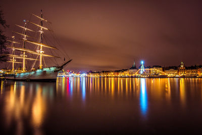 Sailboats in sea at night