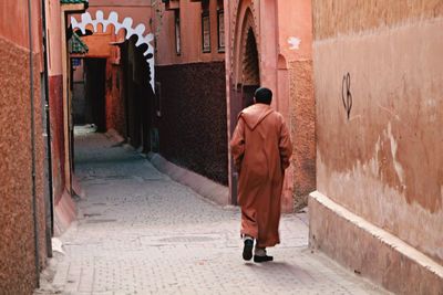 Rear view of man walking on street