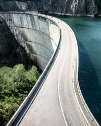 High angle view of dam with lake and ridge