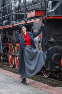 Rear view of woman standing in train