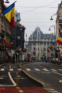 City street and buildings against sky