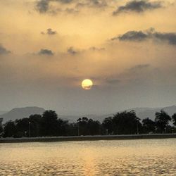 Scenic view of landscape against sky at sunset