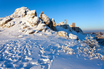 Scenic view of snow covered mountain against clear blue sky