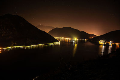 Scenic view of lake against sky at night