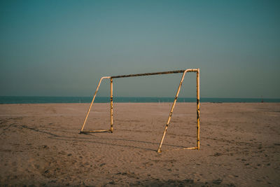 Lifeguard hut on beach against clear sky