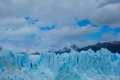 Scenic view of snow capped mountains against sky