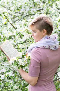 Portrait of cute girl standing amidst plants