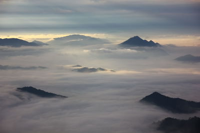 Scenic view of majestic mountains against sky during sunset