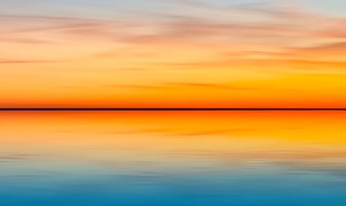Scenic view of sea against romantic sky at sunset