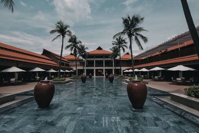 Swimming pool by building against sky