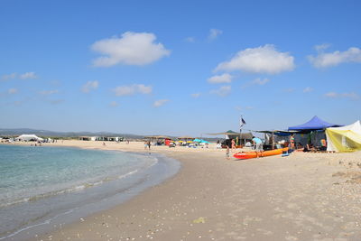 View of people on the beach against sky