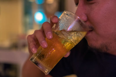 Close-up of a man drinking glass