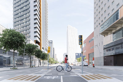 Man with bicycle talking on phone