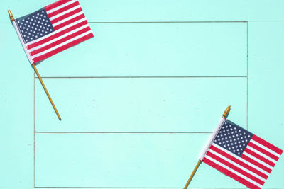 Directly above shot of american flags on turquoise table