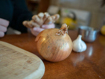 Close-up of hand feeding on table