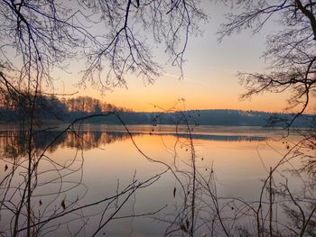 Scenic view of lake against sky at sunset