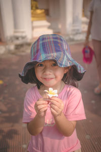 Portrait of cute girl holding camera