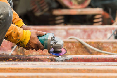 Close-up of man working on metal