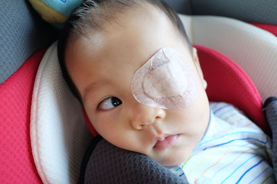 Close-up of baby boy with bandage on eye