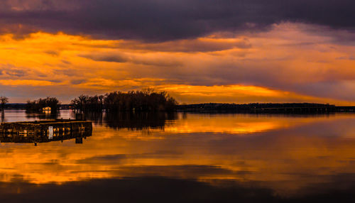 Scenic view of lake against orange sky