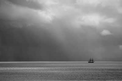 Boat sailing in sea against sky