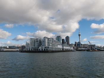 View of sea against buildings in city