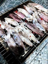 High angle view of fish on barbecue grill