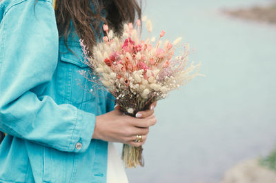 Woman holding flower bouquet