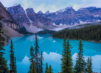 Scenic view of lake and mountains against sky