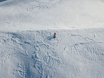 People skiing on snow covered field