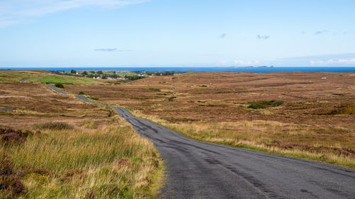 Road by sea against sky