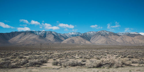 Scenic view of mountains against blue sky