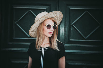 Portrait of young woman wearing hat