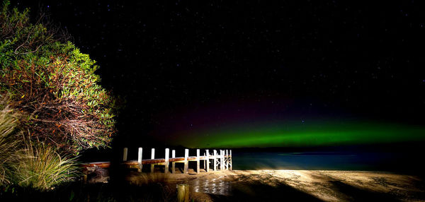 Scenic view of lake against sky at night