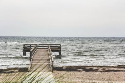 Pier over sea against clear sky