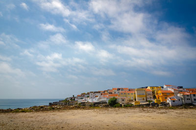 Scenic view of beach by sea against sky