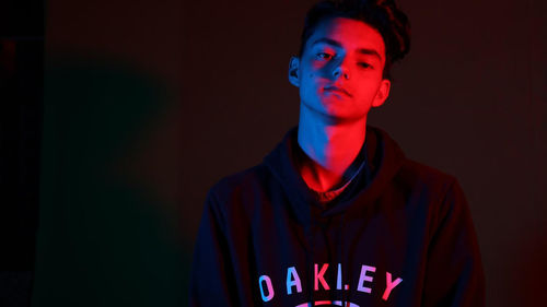 Portrait of young man against blue background