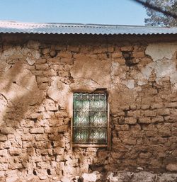 Low angle view of weathered wall of old building