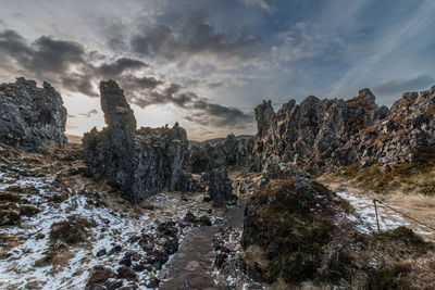 Full frame view of path leading through jagged rock formations before sunset