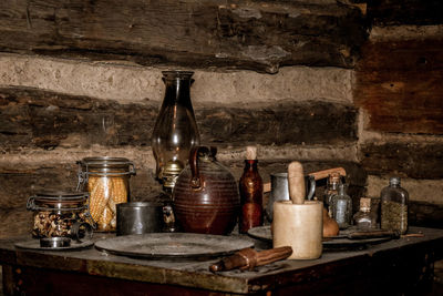 Old bottles on shelf in kitchen
