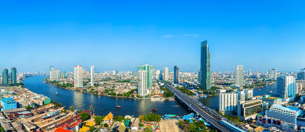 High angle view of buildings against blue sky