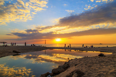 Scenic view of beach against sky during sunset