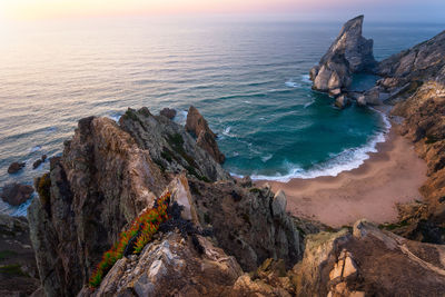 High angle view of rocks on beach against sky