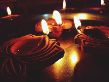 Close-up of lit candles on table