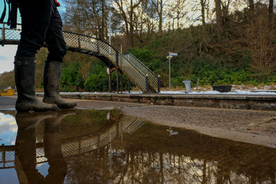 Low section of man working on puddle at lake