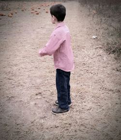 Boy standing on sand