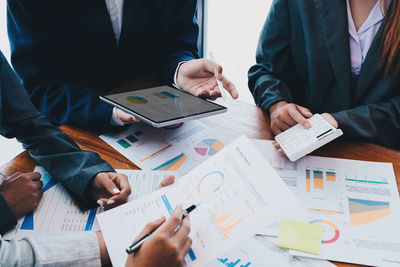 Midsection of business colleagues working at office