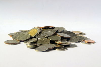 High angle view of coins on white background